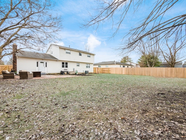 rear view of property featuring central AC, an outdoor hangout area, a patio, and a lawn