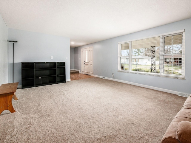 living room with carpet floors and a textured ceiling