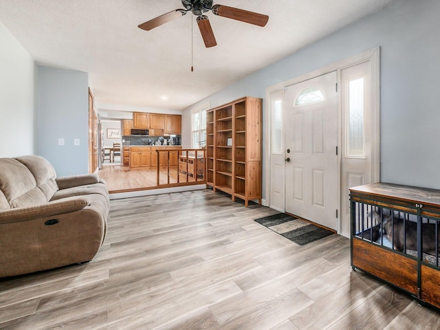 entryway with ceiling fan and light hardwood / wood-style floors