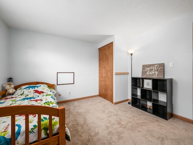 carpeted bedroom featuring a textured ceiling