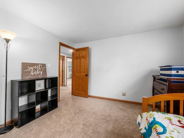 bedroom featuring a textured ceiling and carpet