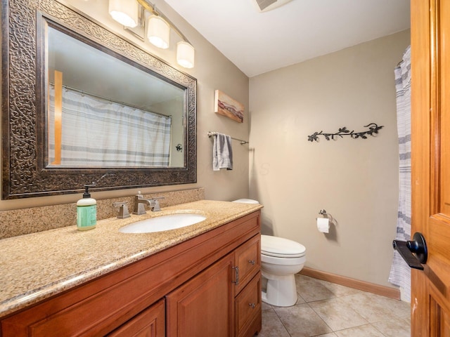 bathroom featuring vanity, tile patterned floors, and toilet