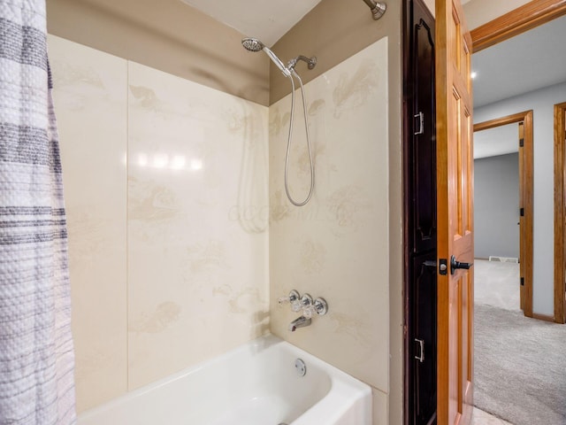 bathroom with shower / bath combo with shower curtain