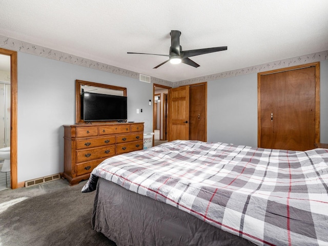 carpeted bedroom with a textured ceiling and ceiling fan