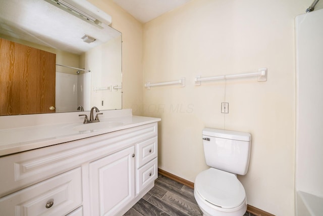 bathroom featuring vanity, toilet, and walk in shower