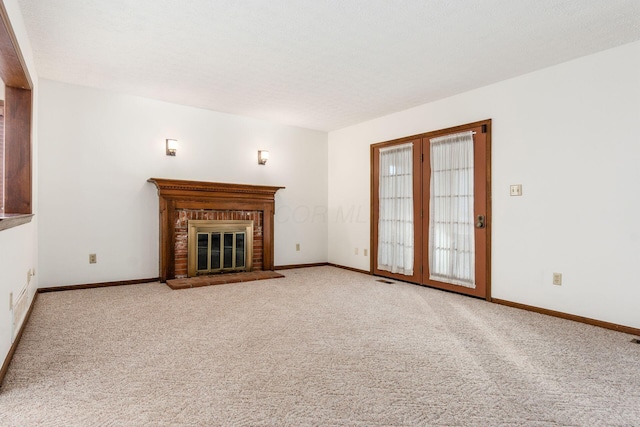 unfurnished living room featuring carpet floors and a fireplace