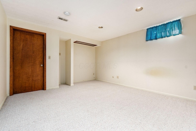 unfurnished room featuring light colored carpet