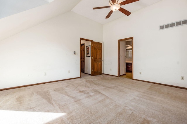 unfurnished room with vaulted ceiling, light colored carpet, and ceiling fan