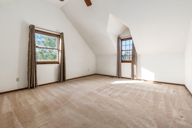 bonus room with light carpet, vaulted ceiling, and ceiling fan