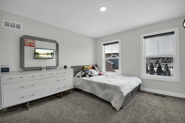 carpeted bedroom featuring a textured ceiling