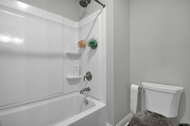 bathroom featuring washtub / shower combination and toilet