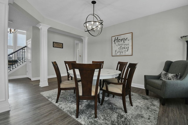 dining space with dark hardwood / wood-style flooring, decorative columns, and a chandelier