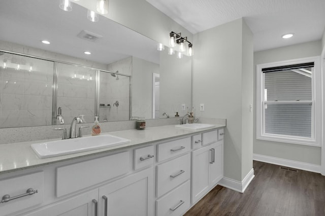 bathroom with vanity, hardwood / wood-style floors, and walk in shower