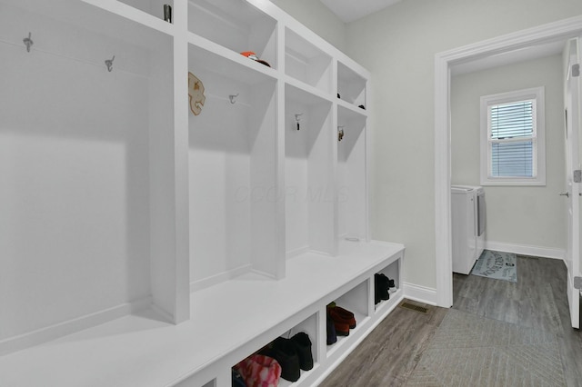 mudroom featuring dark hardwood / wood-style flooring and washer and clothes dryer