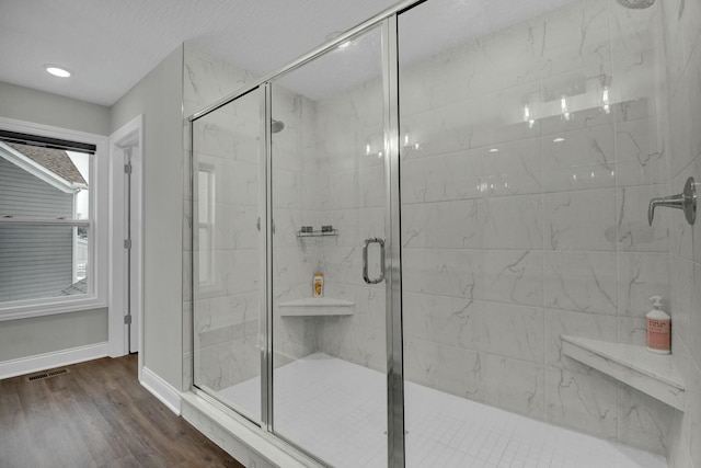 bathroom with walk in shower and wood-type flooring