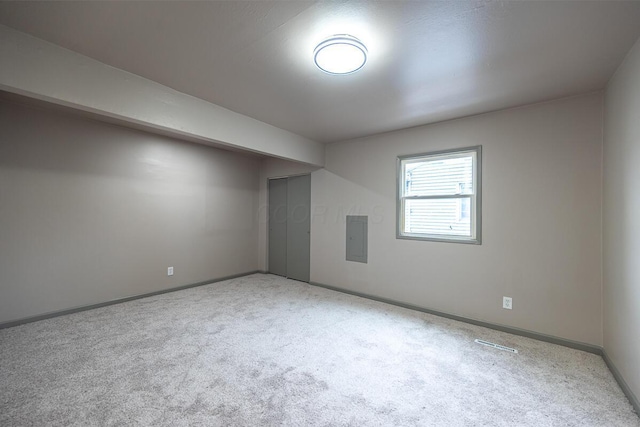 additional living space with electric panel and light colored carpet