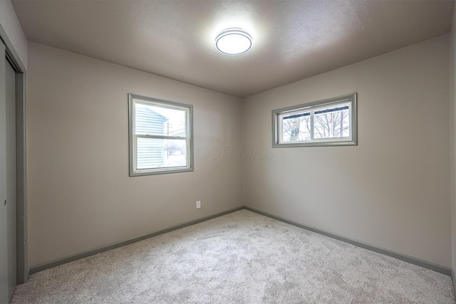 carpeted spare room with plenty of natural light