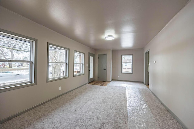 unfurnished room with light colored carpet