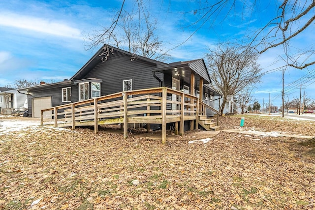 rear view of property with a garage