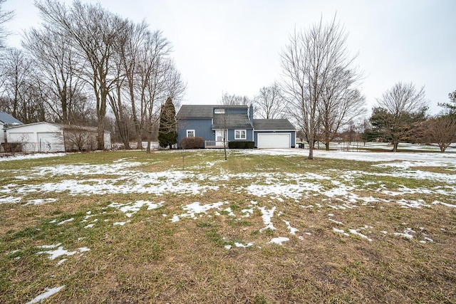 snowy yard with a garage