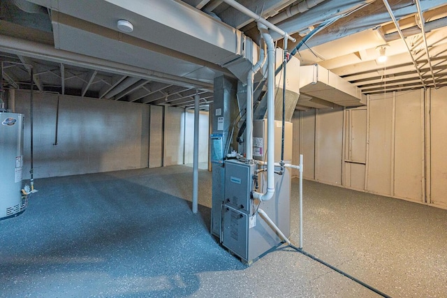 basement featuring heating unit and water heater