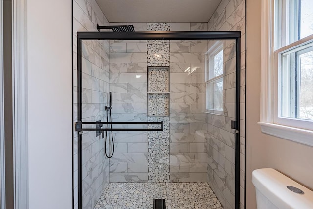 bathroom with an enclosed shower and toilet