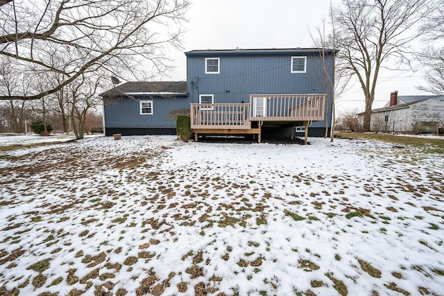 snow covered property featuring a wooden deck