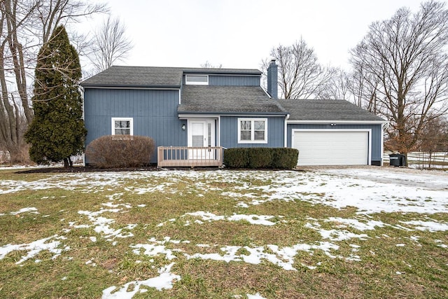 view of front property with a yard and a garage