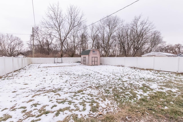 snowy yard with a storage shed