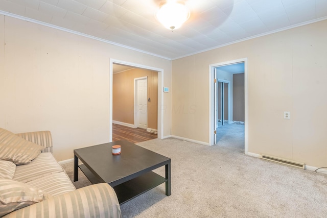 living room with ornamental molding and light colored carpet