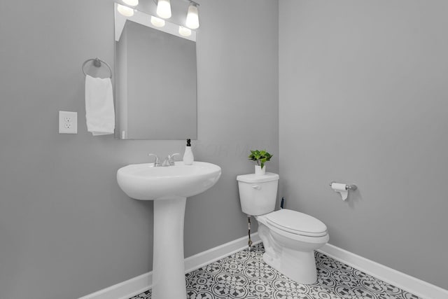 bathroom with tile patterned flooring and toilet