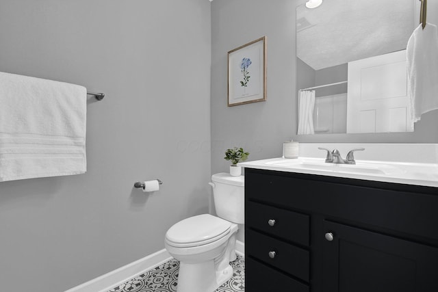 bathroom featuring curtained shower, vanity, toilet, tile patterned floors, and a textured ceiling