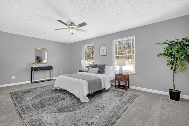 bedroom featuring ceiling fan, carpet flooring, and a textured ceiling