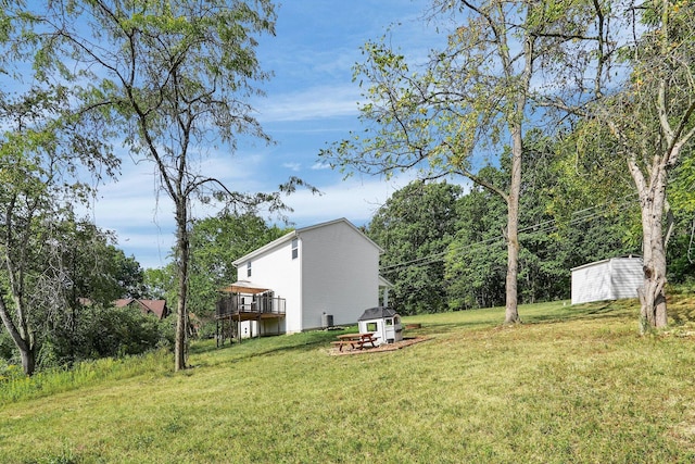 view of yard with a wooden deck and a shed