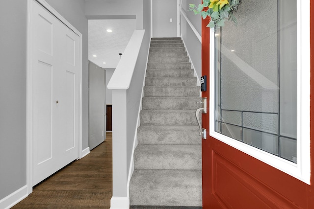 stairway featuring wood-type flooring