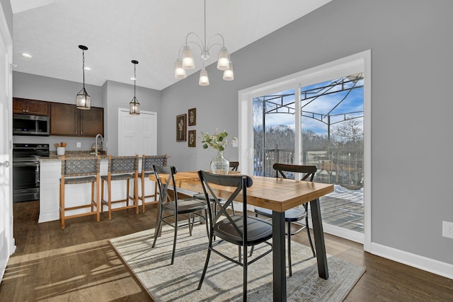 dining space with dark hardwood / wood-style flooring and sink