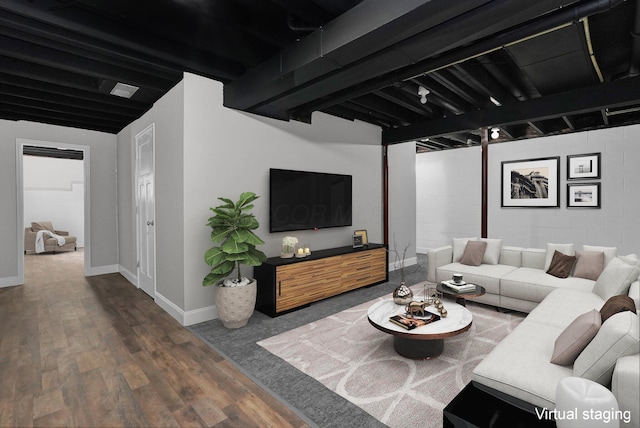 living room with beamed ceiling and dark hardwood / wood-style floors