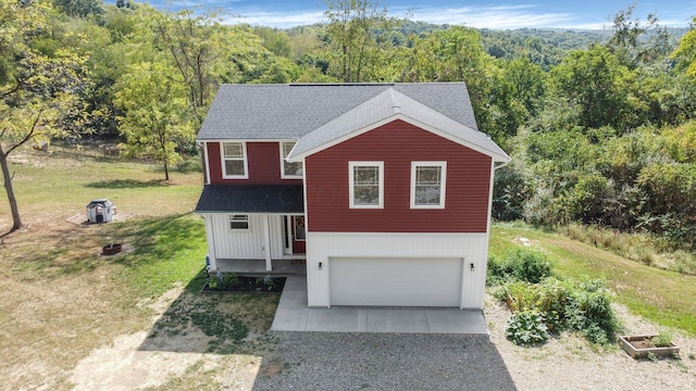 view of front of property with a garage and a front lawn