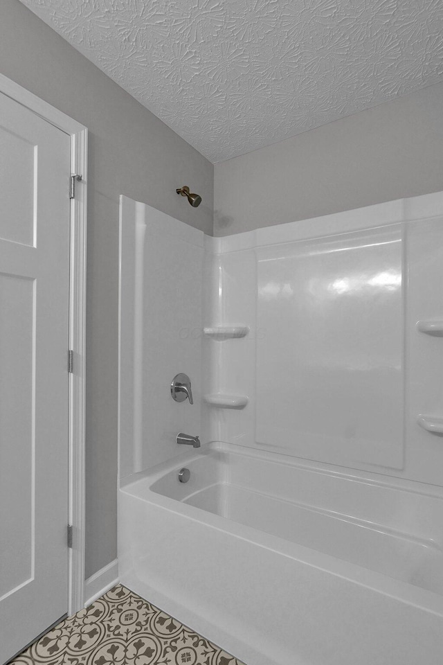 bathroom featuring shower / bath combination and a textured ceiling