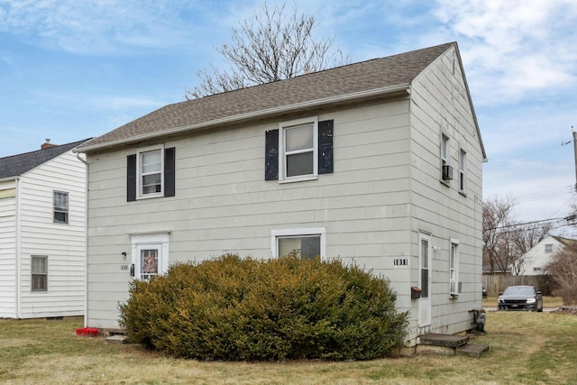 back of house featuring a yard