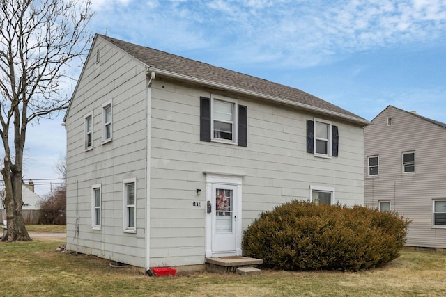 rear view of house with a lawn