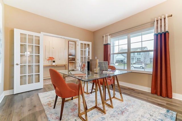 dining room featuring french doors and wood-type flooring