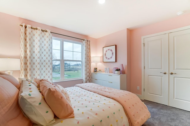 bedroom featuring a closet and dark colored carpet