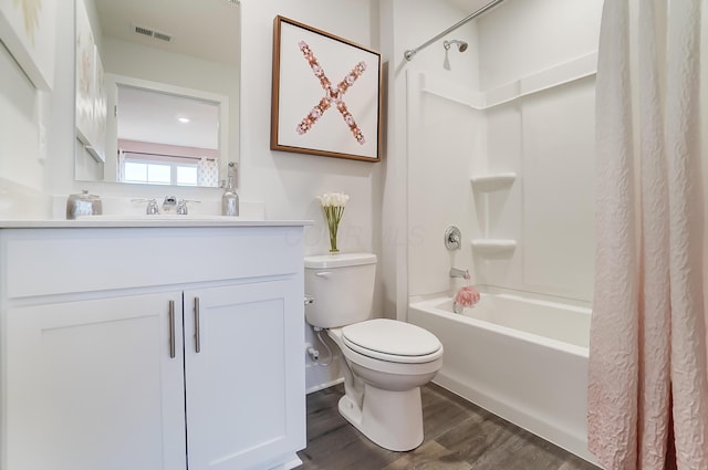 full bathroom featuring hardwood / wood-style flooring, toilet, vanity, and shower / bath combo with shower curtain