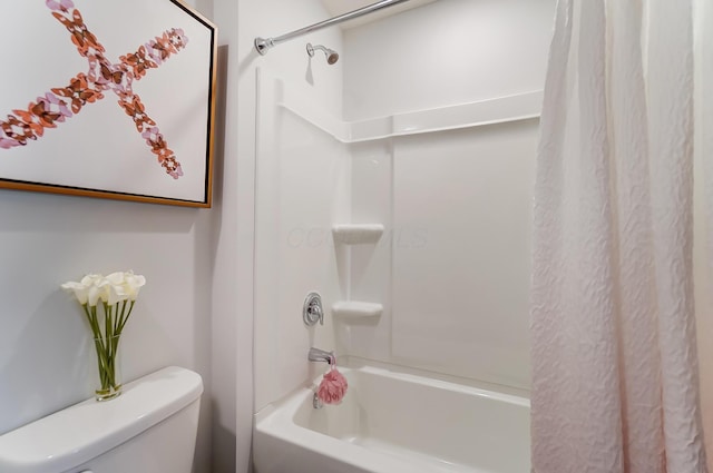 bathroom featuring shower / bathtub combination with curtain and toilet