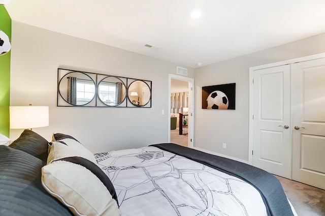 bedroom with light carpet and a closet