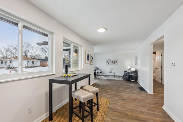 corridor with dark hardwood / wood-style flooring