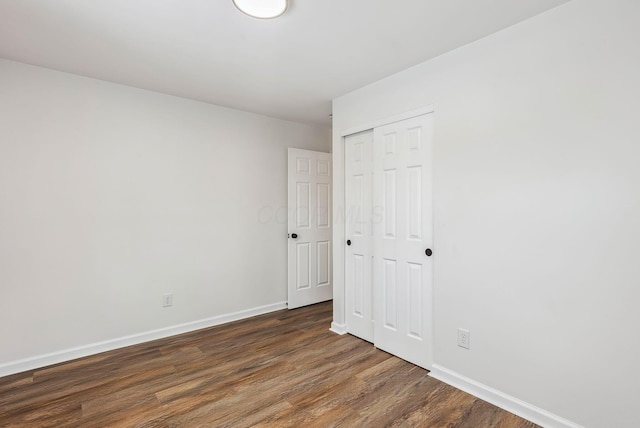 spare room with dark hardwood / wood-style floors