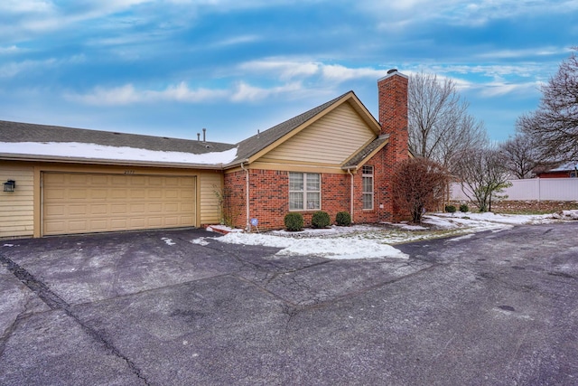 ranch-style house featuring a garage