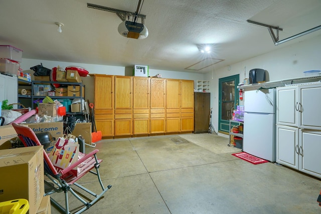 garage featuring a garage door opener and white fridge